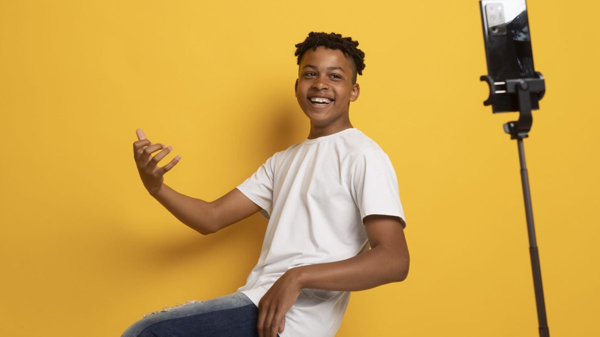 side-view-smiley-teen-recording-video